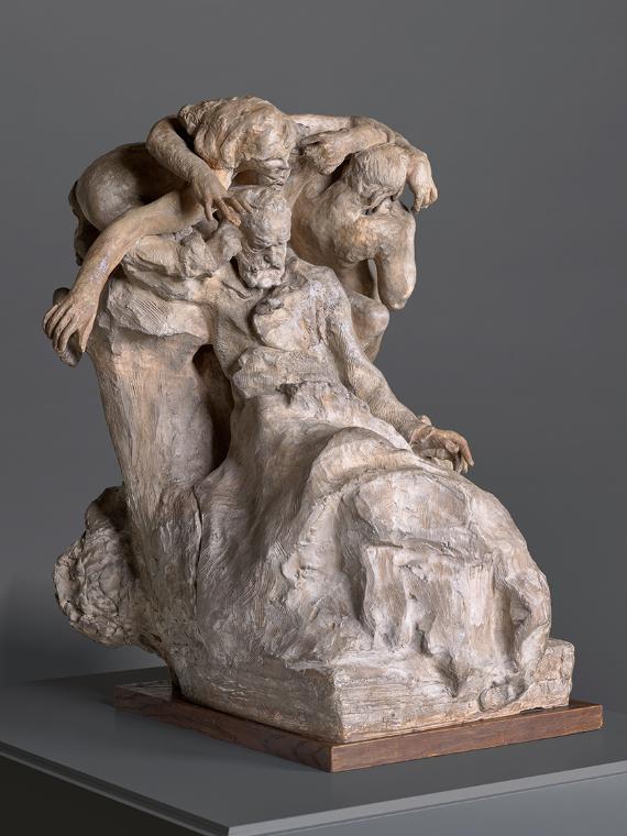 The sculpture depicts a dynamic composition of three figures intertwined closely. A male figure sits prominently in the foreground, while two female figures lean on him and embrace his shoulders. The representation conveys a strong emotional bond between the figures, each taking different poses and exuding a sense of movement and interaction. The texture of the surface is detailed and reminiscent of worked material.

[AI-generated with ChatGPT]
