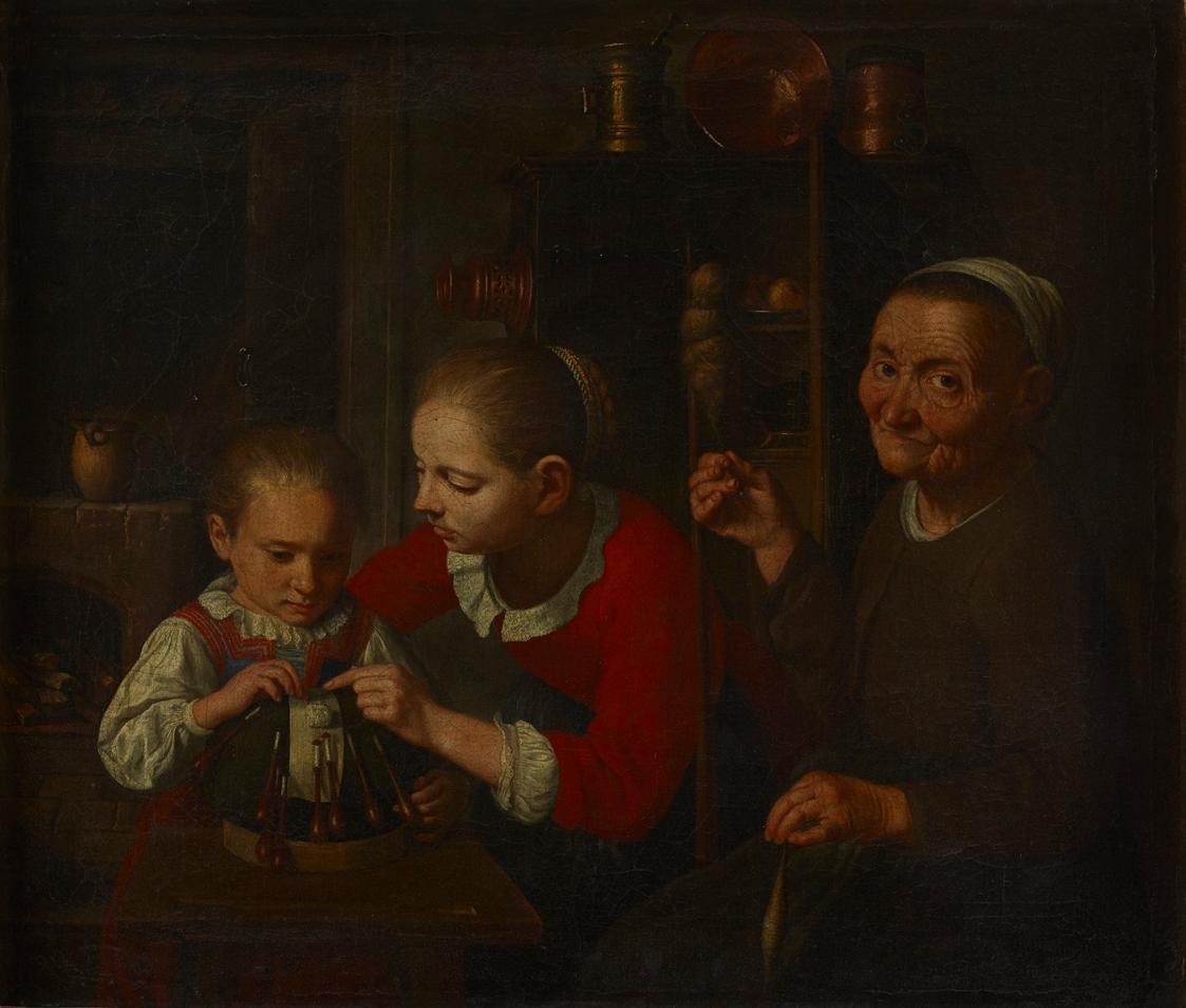 The image depicts three women. An elderly woman is seated on the right, holding an object in her hand. Her features are wrinkled and she has a friendly expression. Two younger women are positioned on the left, engaged in a different activity. One of them, looking at the object, has a concentrated expression, while the other is gazing at her. In the background, various household items are visible, as well as a kind of shelf with utensils. The overall image conveys an intimate, domestic atmosphere…